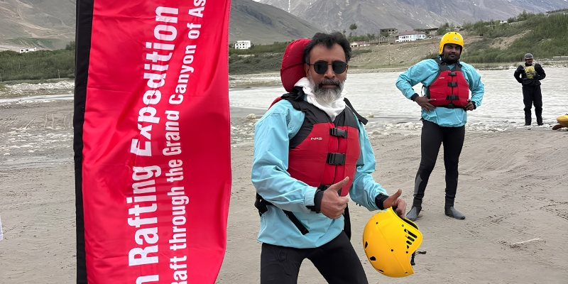 Upper Bhagirathi river expedition guide with red safety flag on the riverbank