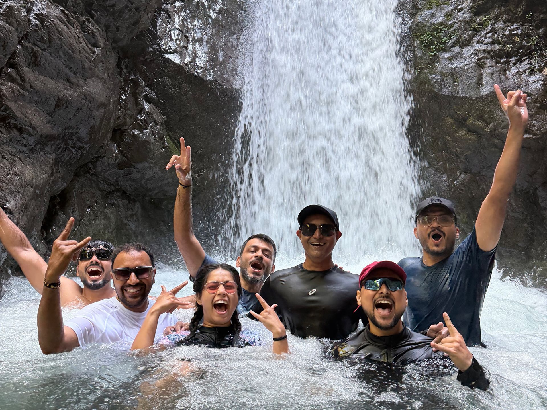 Expedition guests enjoying a waterfall together