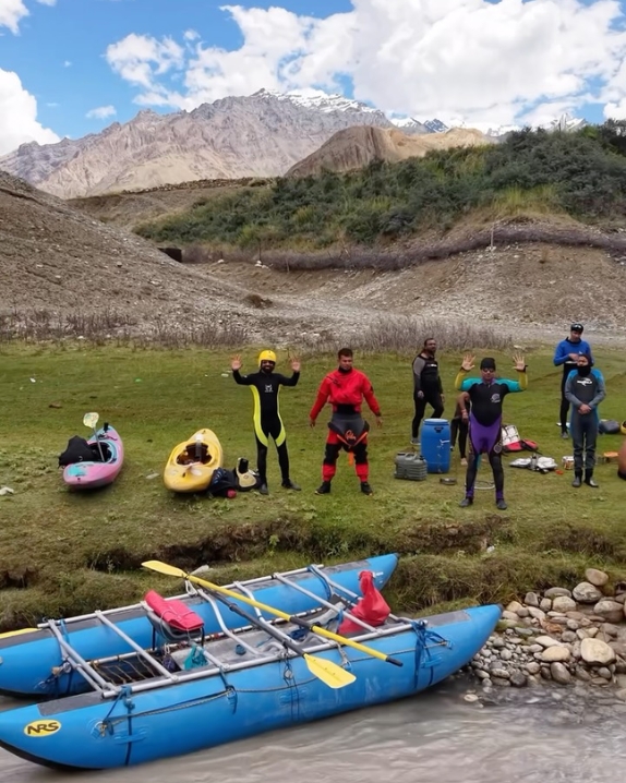 Expedition crew and rafts preparing at a riverside camp