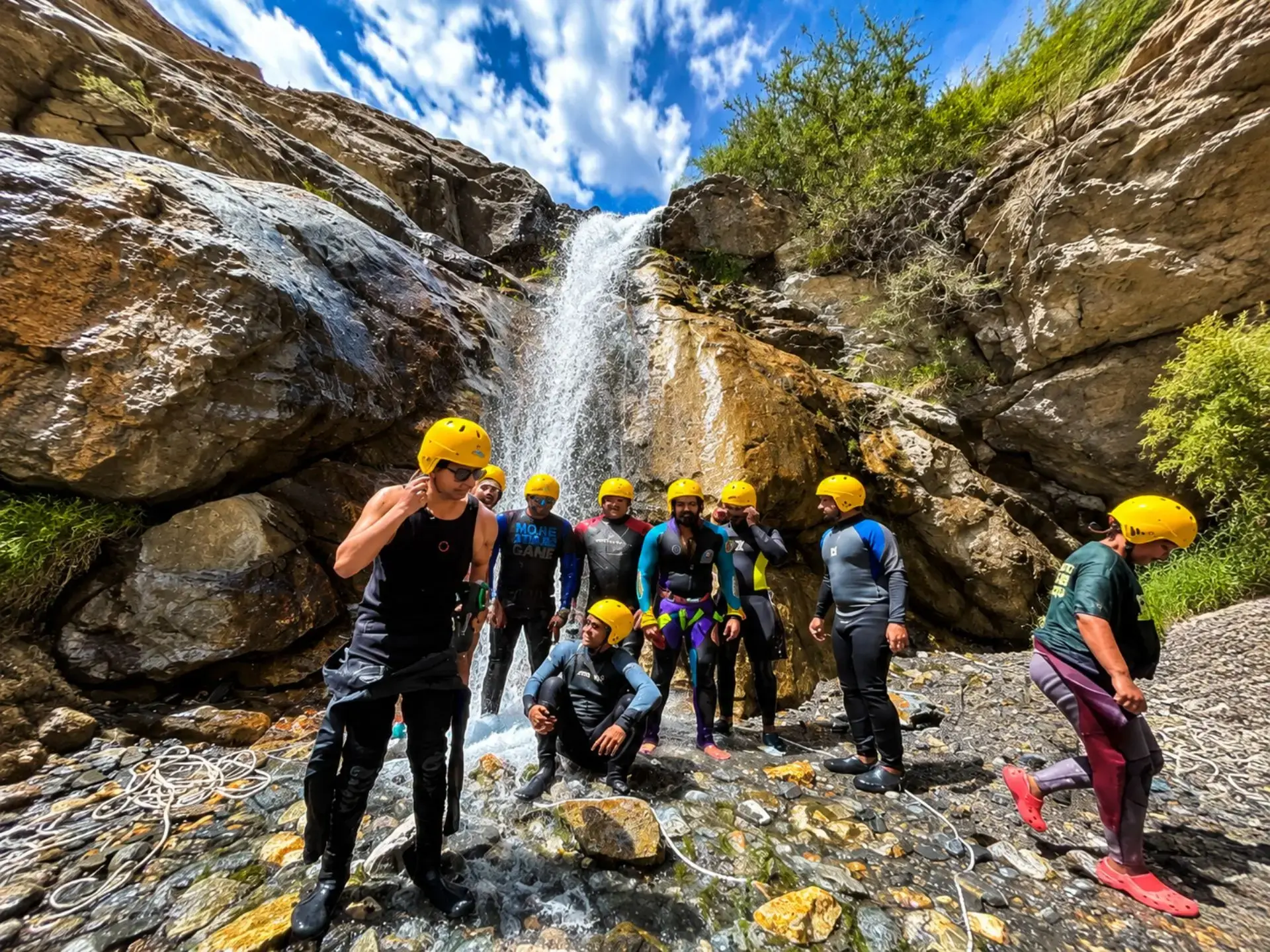 Family rafters gathered at a waterfall