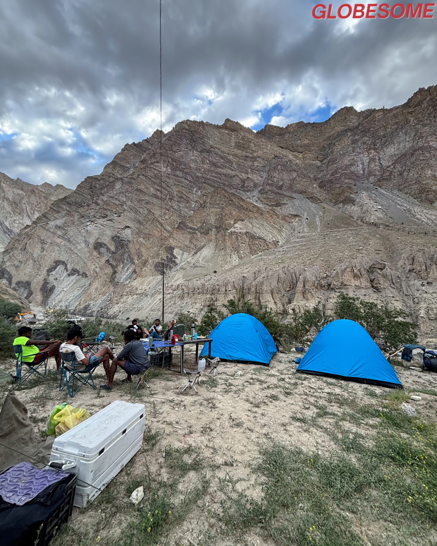 Cliffside pitch under monsoon skies