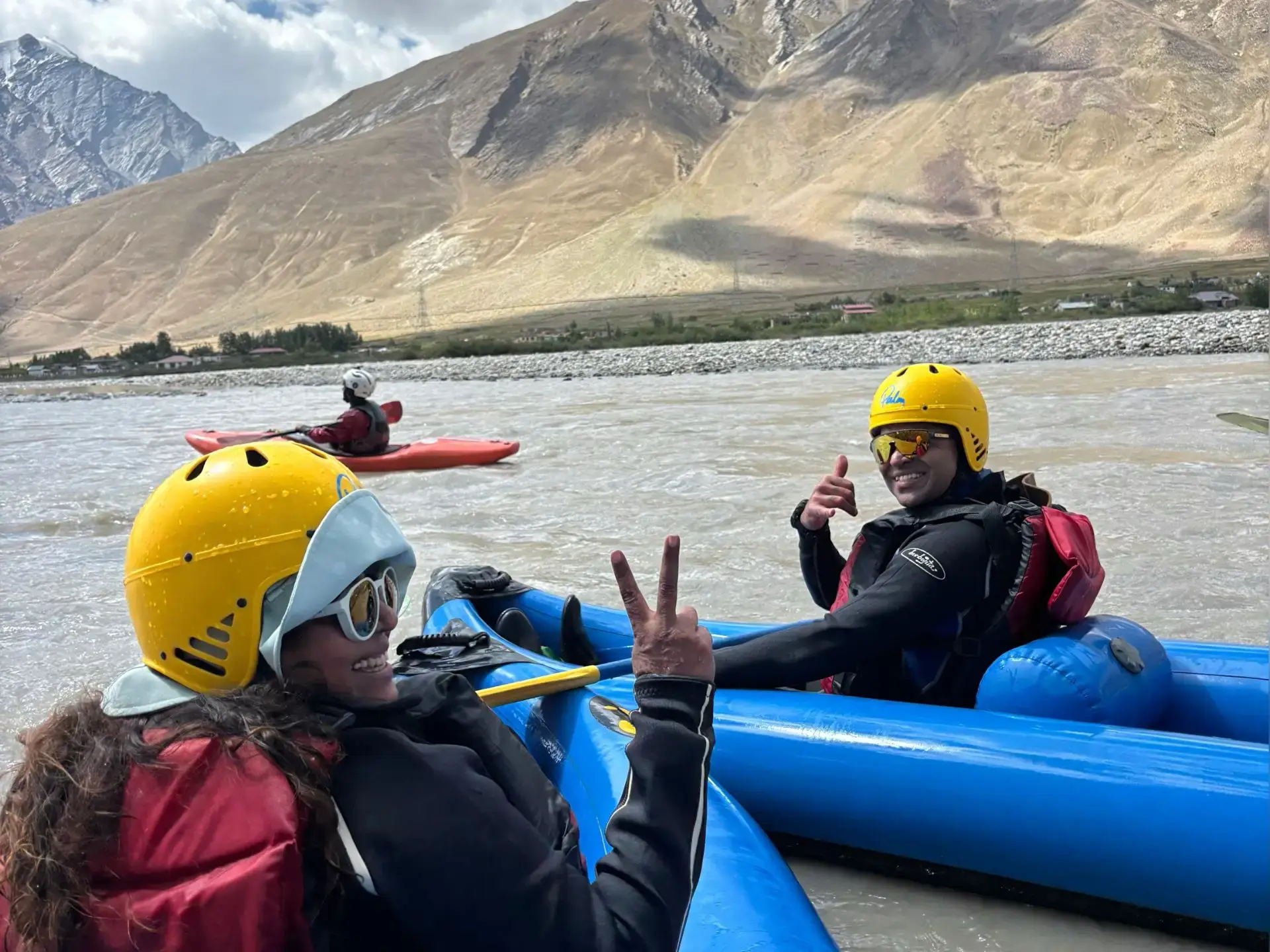 Two equipped guests enjoying a guided rafting trip